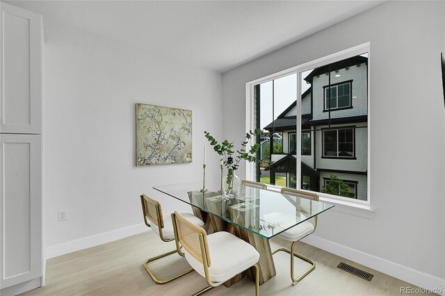 8530 W 52nd Ave Unit A1, Arvada, CO 80002 - dining space featuring baseboards and wood finished floors