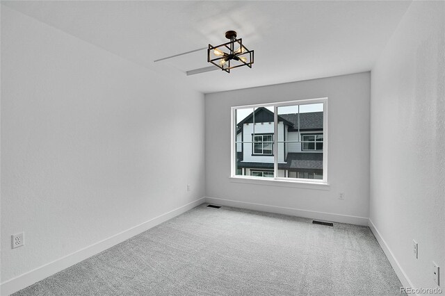 8530 W 52nd Ave Unit A1, Arvada, CO 80002 - unfurnished room featuring a chandelier, carpet, and baseboards