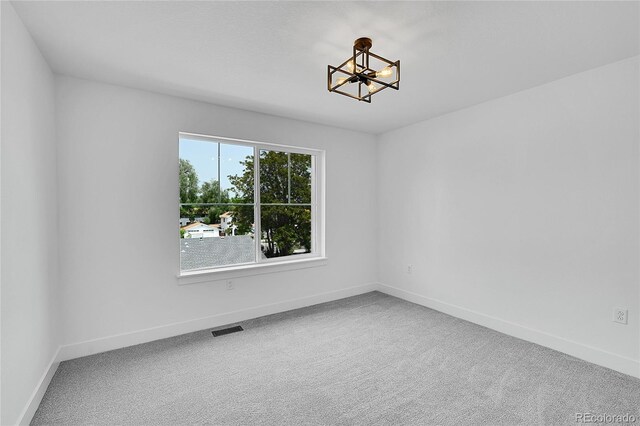 8530 W 52nd Ave Unit A1, Arvada, CO 80002 - unfurnished room featuring a chandelier, carpet floors, and baseboards