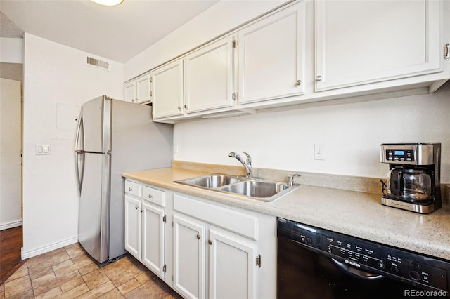 kitchen with a sink, visible vents, white cabinetry, black dishwasher, and light countertops