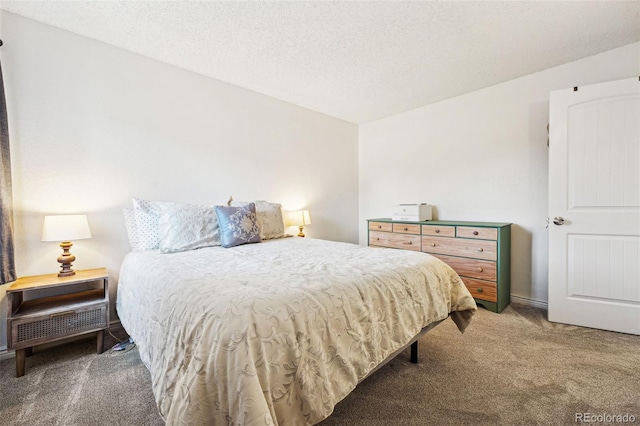 bedroom with a textured ceiling and carpet