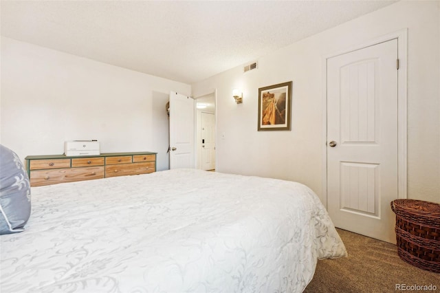 carpeted bedroom featuring visible vents and a textured ceiling