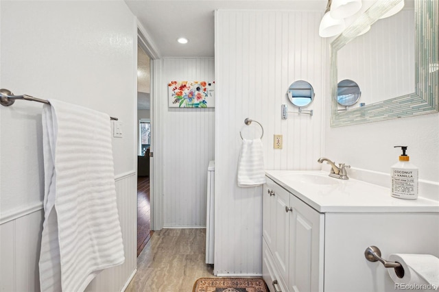 bathroom featuring recessed lighting, wood finished floors, and vanity