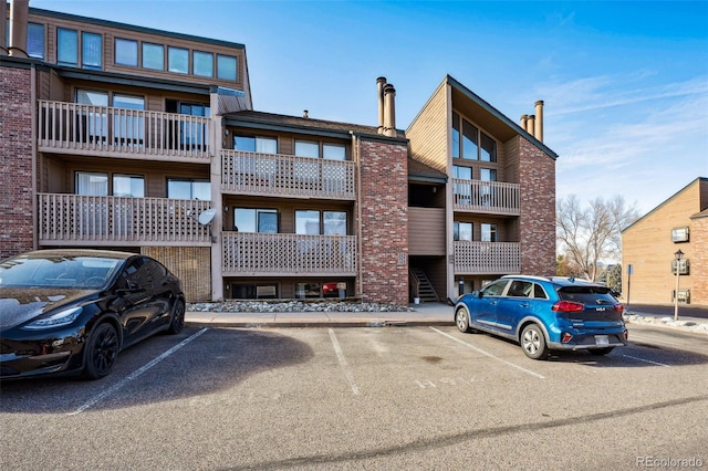 view of property featuring uncovered parking