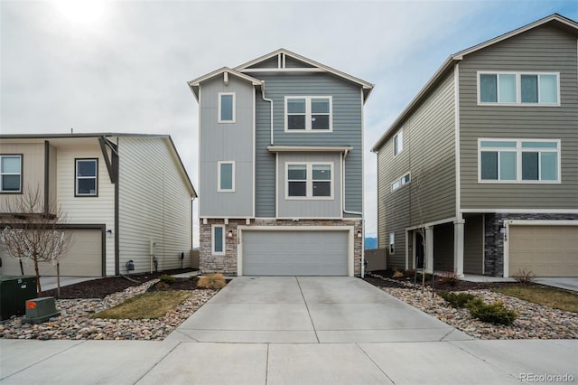 view of front of home featuring stone siding, driveway, and a garage