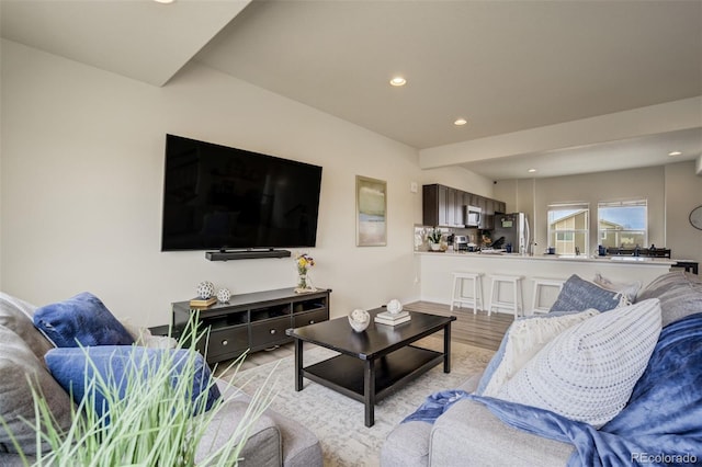 living area featuring recessed lighting and light wood-style flooring