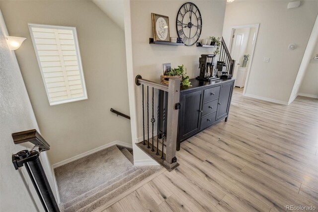 stairs with baseboards and wood finished floors