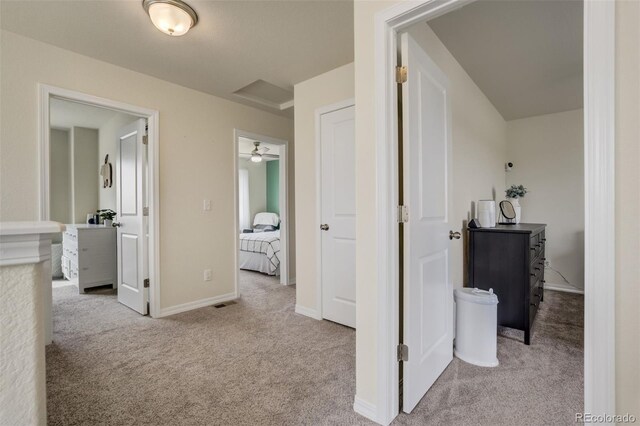 hall with baseboards and carpet