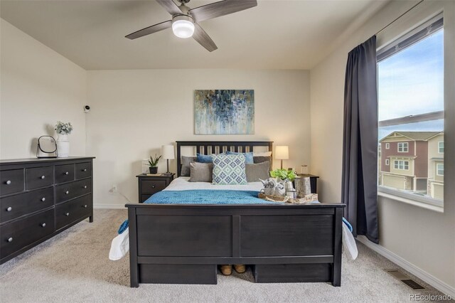 bedroom with light carpet, visible vents, ceiling fan, and baseboards