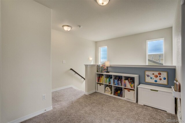 recreation room featuring plenty of natural light, baseboards, and carpet floors