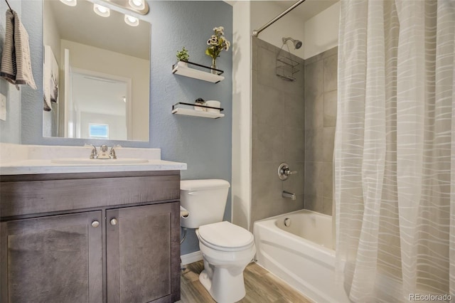 full bathroom with shower / bath combo with shower curtain, toilet, wood finished floors, vanity, and a textured wall