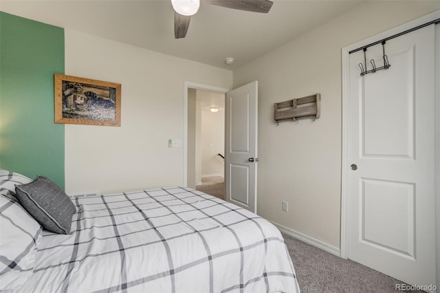 bedroom with a closet, carpet floors, baseboards, and ceiling fan
