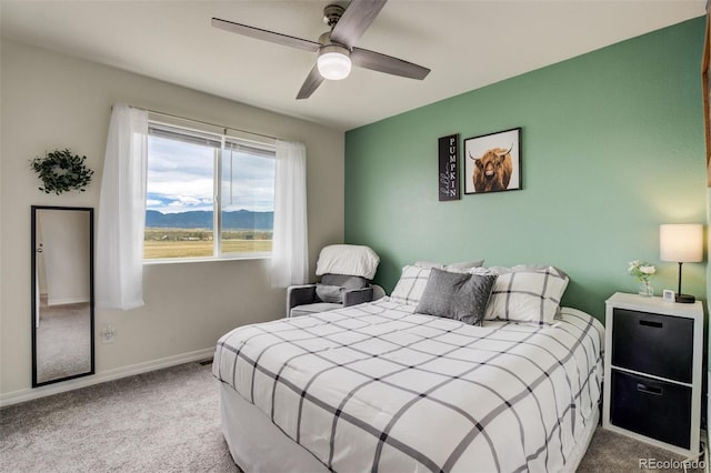 carpeted bedroom with a ceiling fan and baseboards