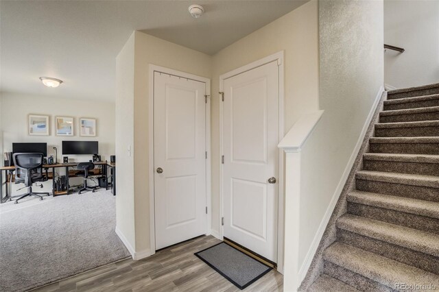 stairway with baseboards and wood finished floors