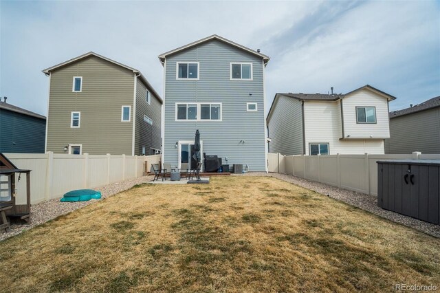 back of house with cooling unit, a patio area, a lawn, and a fenced backyard