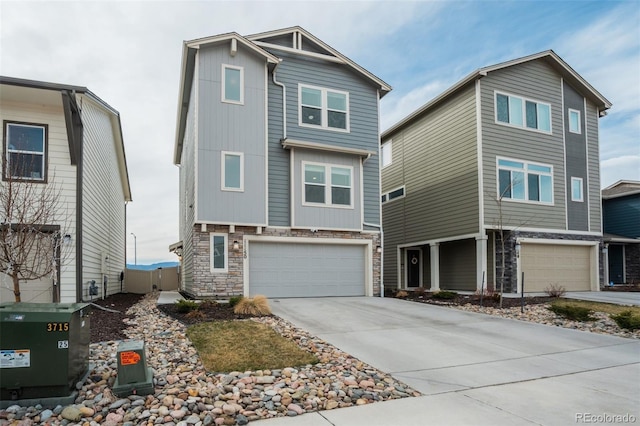 view of front of property with stone siding, concrete driveway, and a garage
