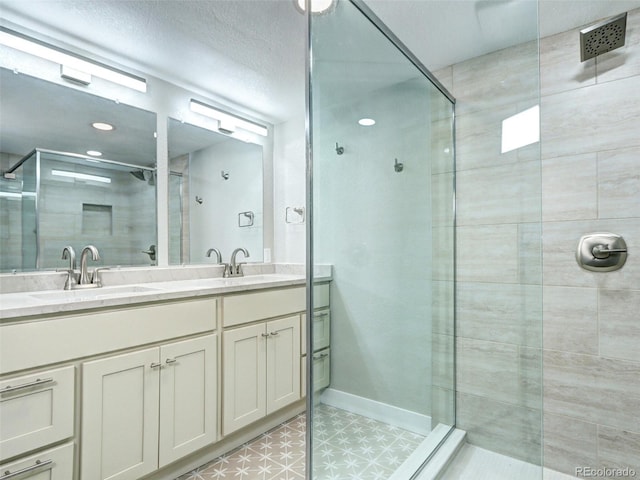 full bathroom with a shower stall, double vanity, and baseboards