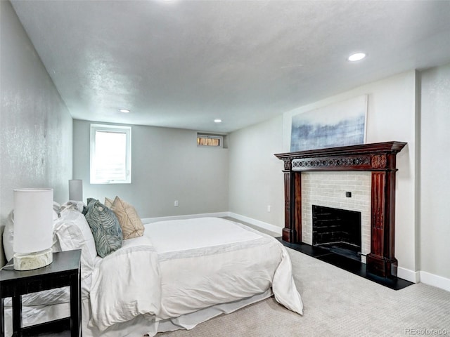 carpeted bedroom with a brick fireplace, recessed lighting, and baseboards