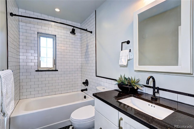 full bath with toilet, vanity, shower / tub combination, and backsplash