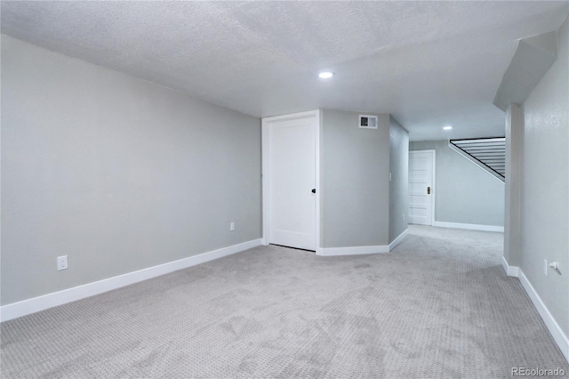 additional living space featuring light carpet, recessed lighting, baseboards, and a textured ceiling