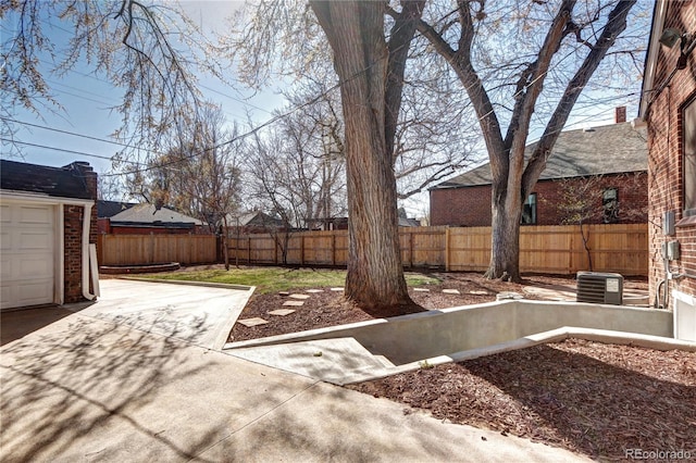 fenced backyard with central AC and a patio