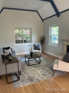 1378 Forest St, Denver, CO 80220 - living area featuring lofted ceiling, wood finished floors, baseboards, and a fireplace