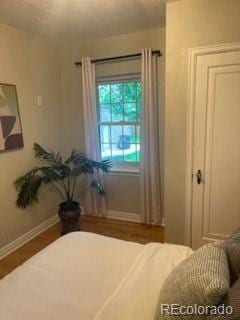1378 Forest St, Denver, CO 80220 - bedroom featuring baseboards and wood finished floors