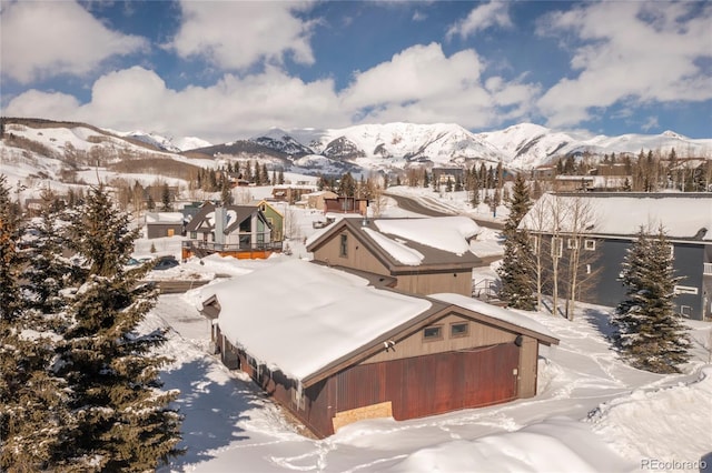 snowy aerial view featuring a mountain view