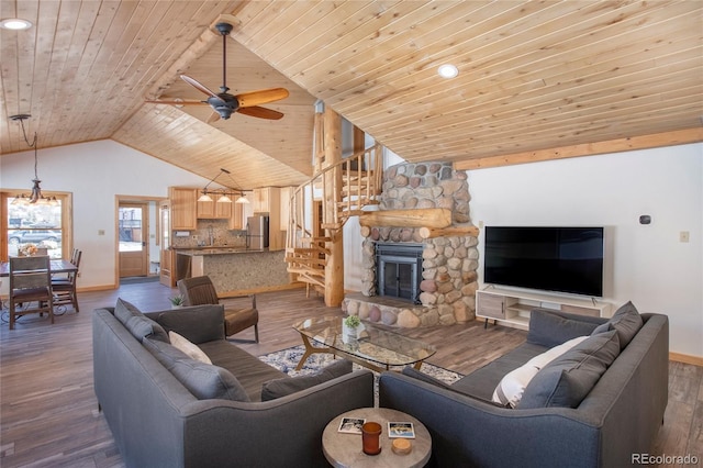 living room with a stone fireplace, dark wood-type flooring, and wooden ceiling