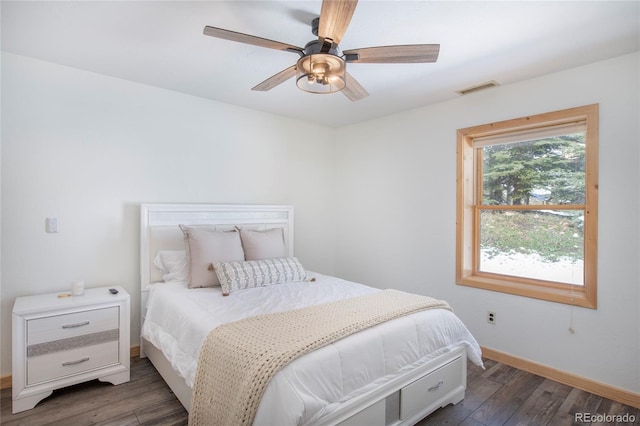 bedroom with ceiling fan and dark hardwood / wood-style flooring