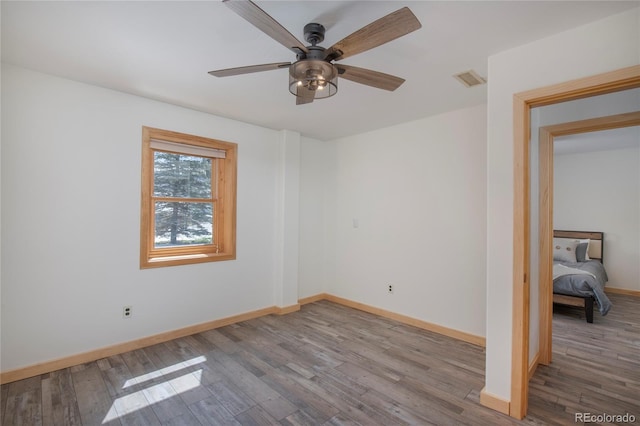 spare room featuring light hardwood / wood-style flooring and ceiling fan