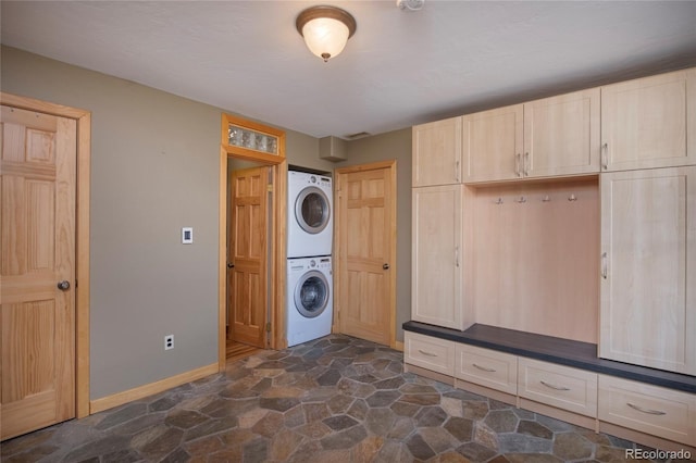 laundry room with stacked washer and clothes dryer