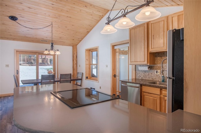 kitchen featuring dark wood-type flooring, vaulted ceiling, wood ceiling, stainless steel appliances, and a chandelier