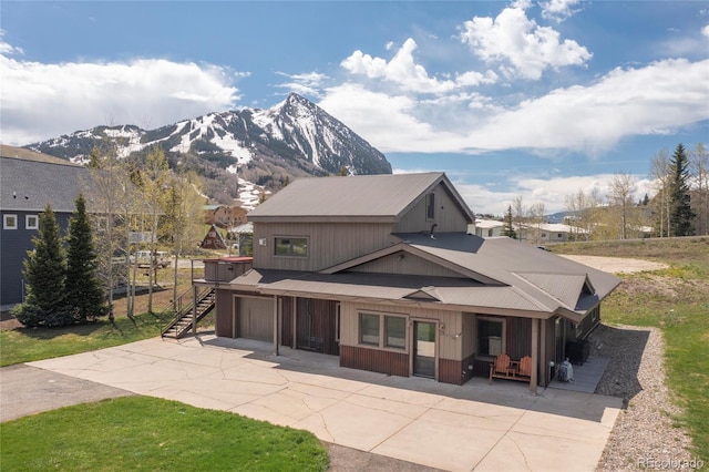 exterior space with a mountain view and a garage