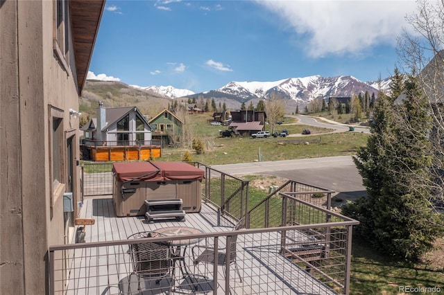 wooden terrace with a mountain view and a hot tub