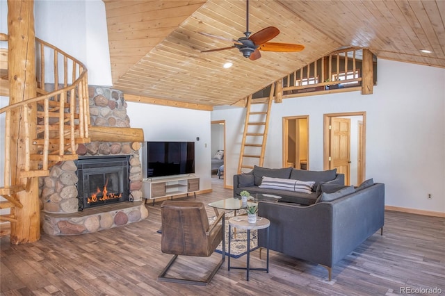 living room featuring a fireplace, hardwood / wood-style flooring, ceiling fan, and wood ceiling