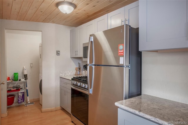 kitchen with appliances with stainless steel finishes, light wood-type flooring, white cabinetry, and wood ceiling