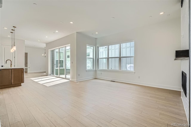 910 Promenade Dr, Superior, CO 80027 - unfurnished living room with baseboards, light wood finished floors, a fireplace, and recessed lighting