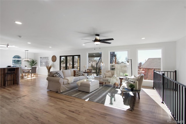 living room with ceiling fan and wood-type flooring