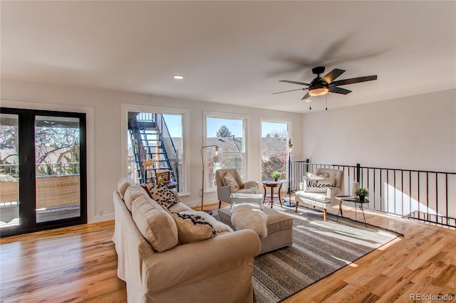 living room featuring ceiling fan and light hardwood / wood-style flooring