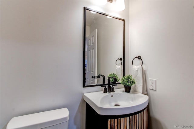 bathroom featuring toilet and vanity