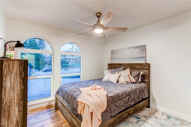 bedroom with ceiling fan, access to outside, and light wood-type flooring