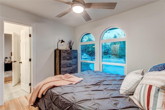 bedroom with ceiling fan and light hardwood / wood-style floors