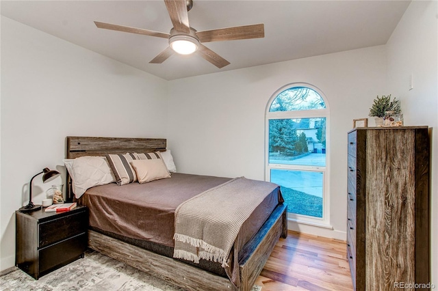 bedroom with ceiling fan and light hardwood / wood-style flooring