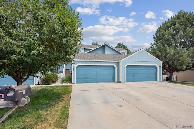 943 Reynolds Farm Ln Unit D8, Longmont, CO 80503 - view of front of property featuring a garage, concrete driveway, a front yard, and a shingled roof
