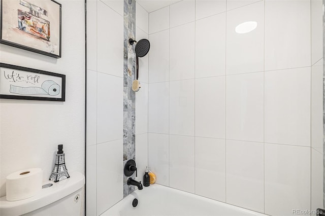 bathroom featuring tub / shower combination and toilet