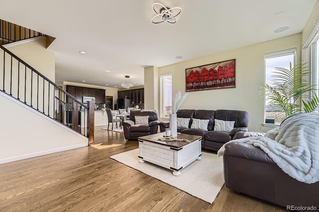 living area with stairway, wood finished floors, baseboards, and recessed lighting