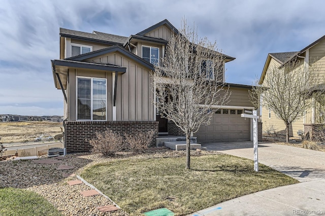 view of front of home with board and batten siding, driveway, brick siding, and a front lawn
