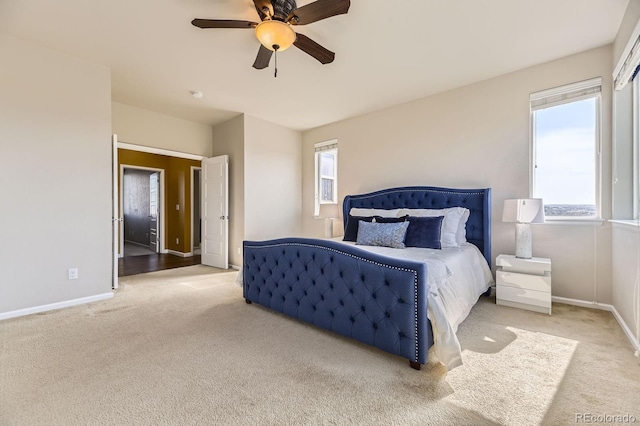 bedroom with carpet floors, baseboards, and a ceiling fan