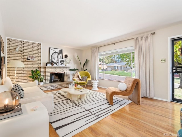 living room with a fireplace and light wood-type flooring